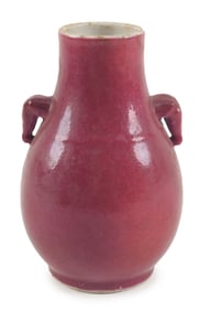 Porcelain vase. China. 19th century. Pear shaped with elephant mark handles. Magenta glaze.
