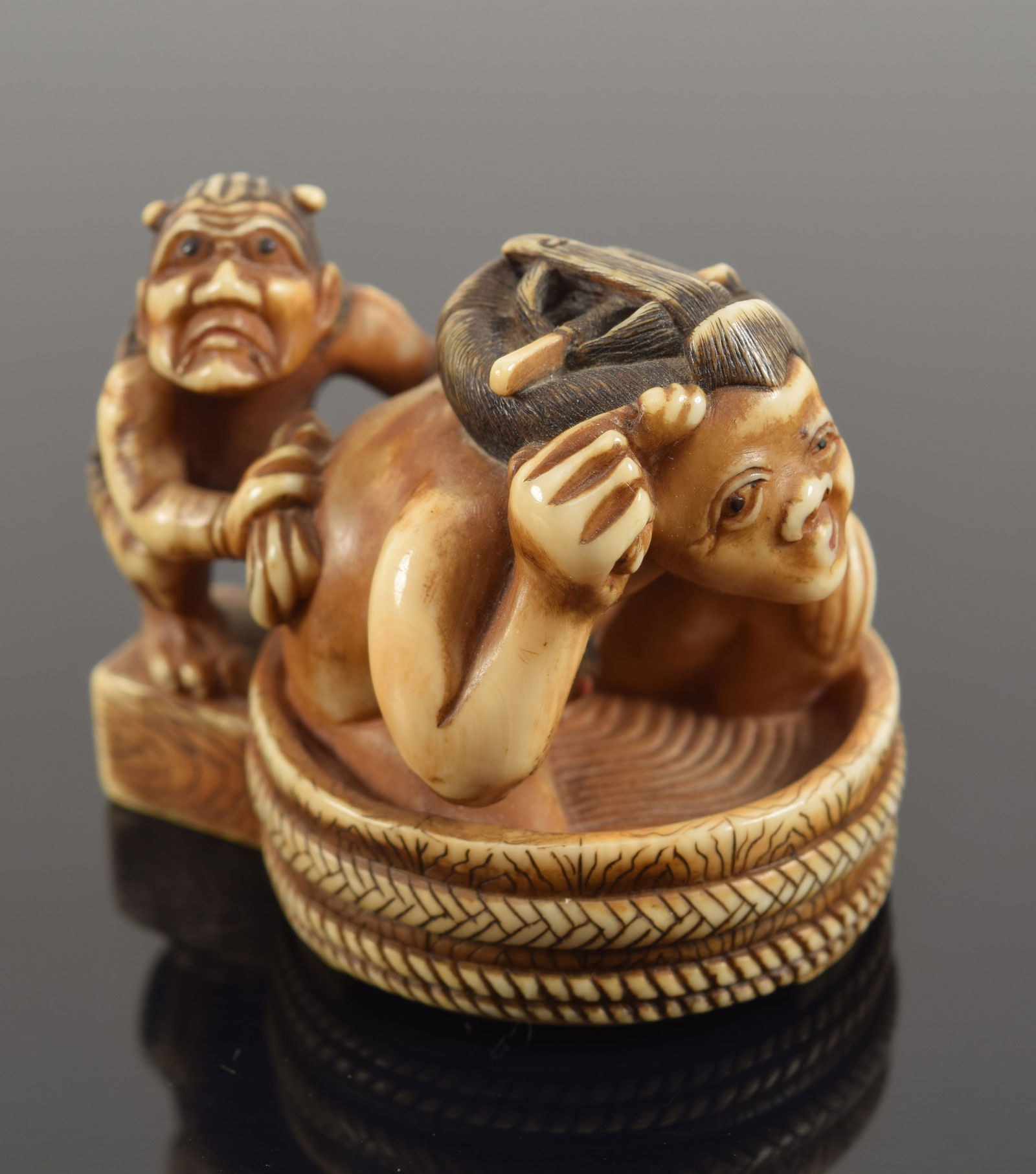 Carved toggle. Japan. 19th century. Netsuke of an Oni bathing a woman. Signed Hidemasa. 1.5in (1 of 6)