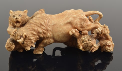 Carved okimono. Japan. 19th century. Combat scene of a bear and two tigers attacking a bull. 4.5 x