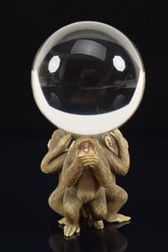 Rock crystal sphere on three monkeys stand. Overall: 4.5in. Sphere: 2.25in.