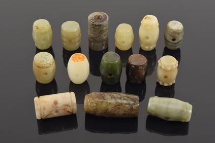 Lot of 13 jade beads. China. Each about 1in length.