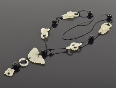 Necklace. China. 19th century. Jade carved as butterflies, rings and black beads.