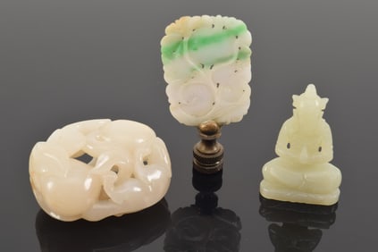 Lot of 3 jades. China. 19th century. To include: a pebble carved with chih lung and lotus, a seated