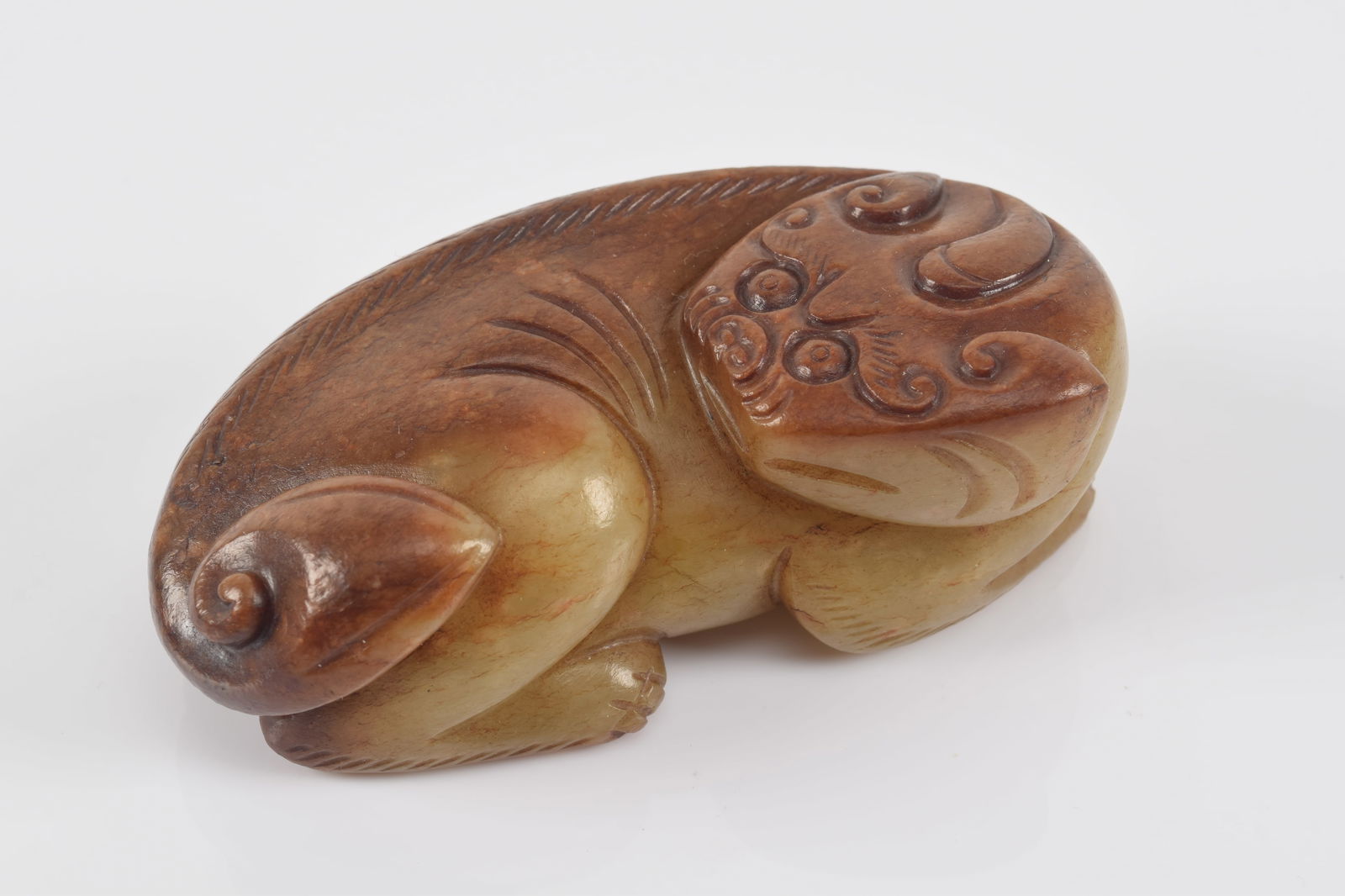 Mythical single horned animal. China. Ming period (1368-1644). Yellow jade with a pronounced brown: Mythical single horned animal. China. Ming period (1368-1644). Yellow jade with a pronounced brown marking. 3.5in.