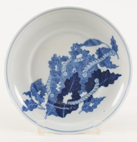 Porcelain saucer dish. China. Early 20th century. Underglaze blue decoration of silk worms feeding
