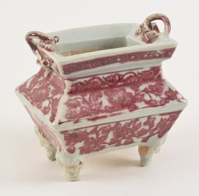 Porcelain censer. China. 19th century. Rectangular form with 4 animal mask feet. Underglaze red