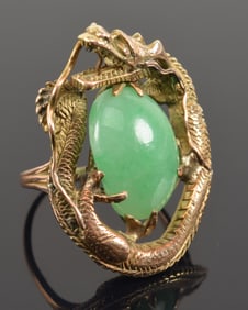 Jade cabochon ring. Set in 14K gold with dragon surrounding the stone.