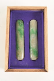 Pair of jade paperweights. China. 20th century. Surface carved with bats and peaches. 5in length.