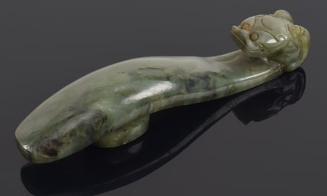 Green jade garment hook. China. 20th century. Repair on neck. 4.75in length.