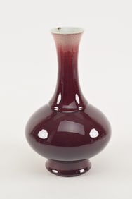 Oxblood porcelain vase. China. 19th century. Drilled and weighted. Chip on rim. 18in high.