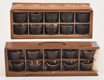 2 boxed sets of silver inlaid coconut shell cups. China. 19th/early 20th century.
