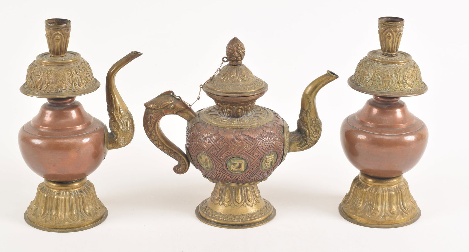3 repousse copper vessels. Tibet. 19th century. To include: a ewer and 2 elements from an altar set (1 of 6)