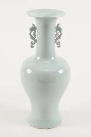 Porcelain vase. China. Early 20th century. Pale celadon glaze. Surface engraved with floral