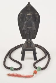 Lot of 2. China. 20th century. To include: an agar wood and jade rosary together with a bronze image