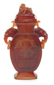 Carved carnelian jar and cover. China. 20th century. Foo dog jump rings and finial. Surface carved