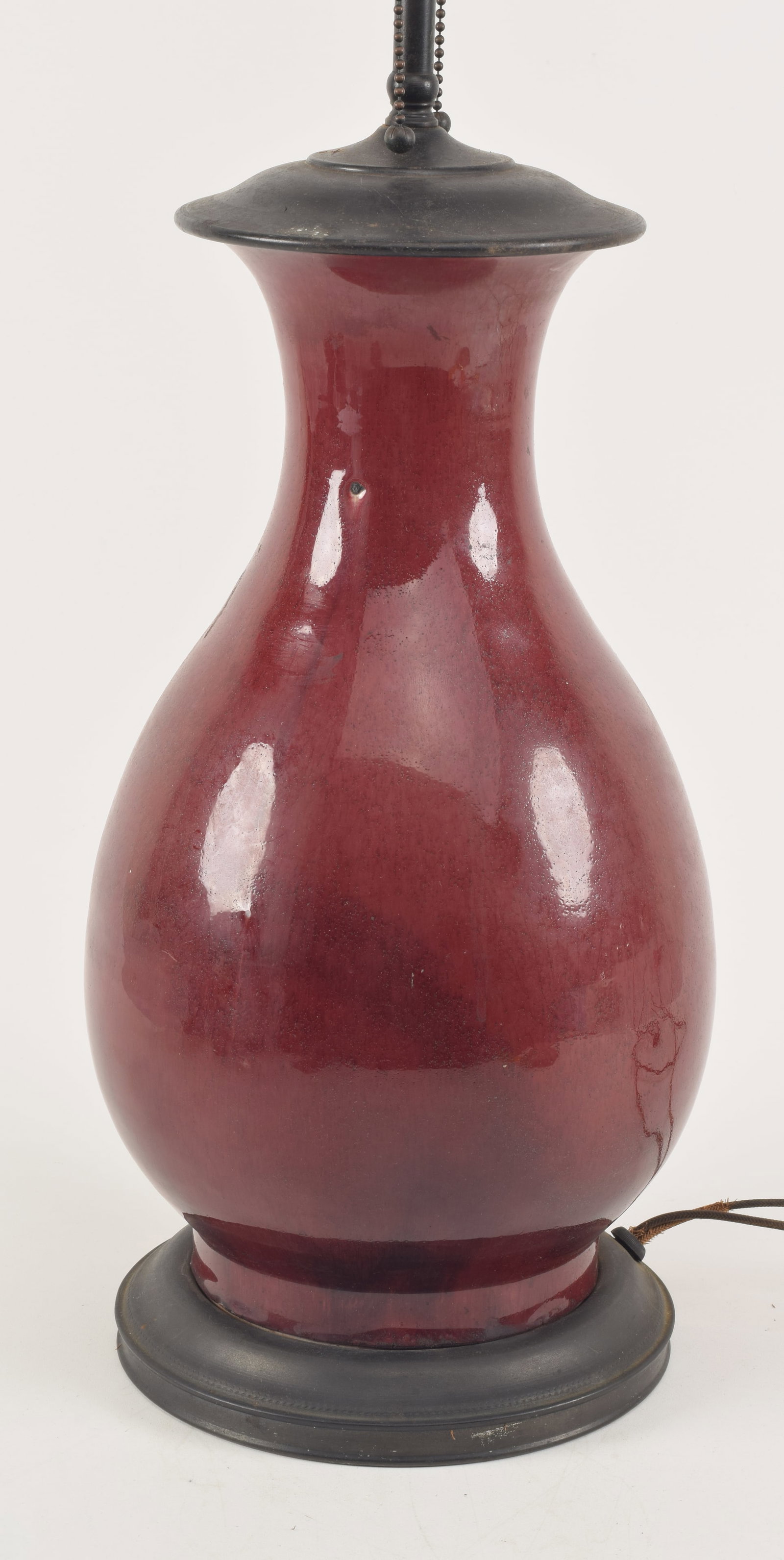 Lang yao oxblood vase. China. 19th century. Pear shaped with a deep red glaze. Drilled and mounted: Lang yao oxblood vase. China. 19th century. Pear shaped with a deep red glaze. Drilled and mounted as a lamp. 25in overall.