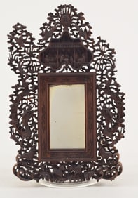 Carved sandalwood mirror frame. China. 19th century. Canton style work of figures in palace gardens.