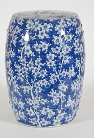 Porcelain garden stool. China. 20th century. Underglaze blue prunus decoration. 19in high.