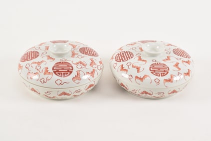 Pair of porcelain covered bowls. China. 20th century. Iron red decoration of bats and shou