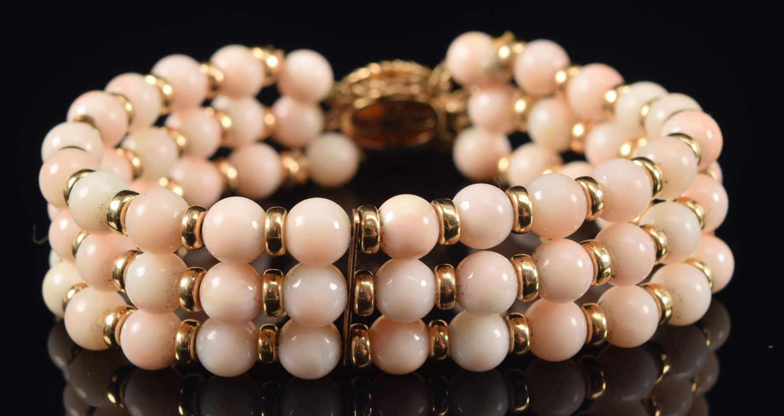 14K gold angel skin coral bead multi-strand bracelet. Alternating coral and gold beads with a clasp