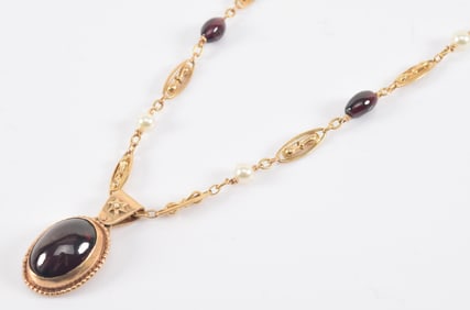 Vintage 14K gold garnet and pearl pendant necklace. Necklace with wirework segments and alternating