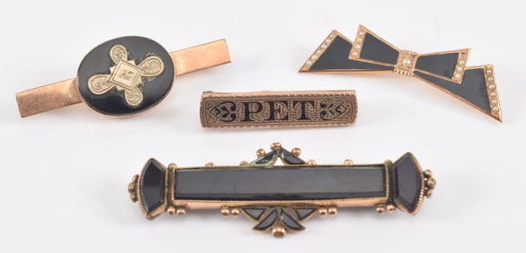 4 antique gold pins with onyx and black enamel decoration. One bow form, another with "Pet". Total