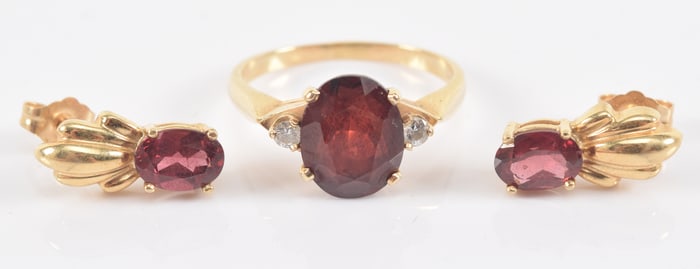 14K gold garnet ring and earrings. 1) Ring with oval cut garnet measuring 8 x 10mm flanked by 2