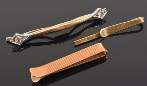 3 14K gold tie clips. One white and yellow gold with 2 round cut diamonds measuring about 3.2mm