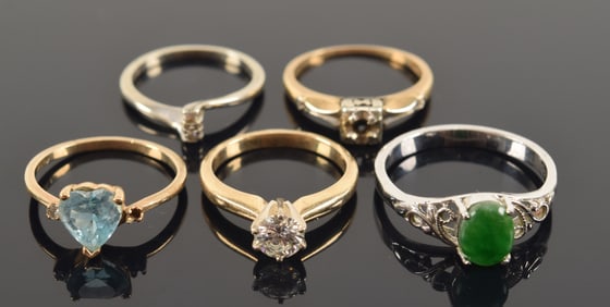Lot of 5 rings including gold. 1) 14K gold diamond solitaire ring. Stone measures 5.3mm diameter.