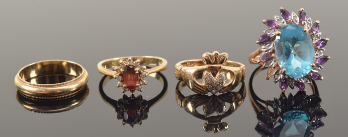 Lot of 4 gold rings. To include: 14K claddagh ring, 14K wedding band, 14K garnet and tiny diamond