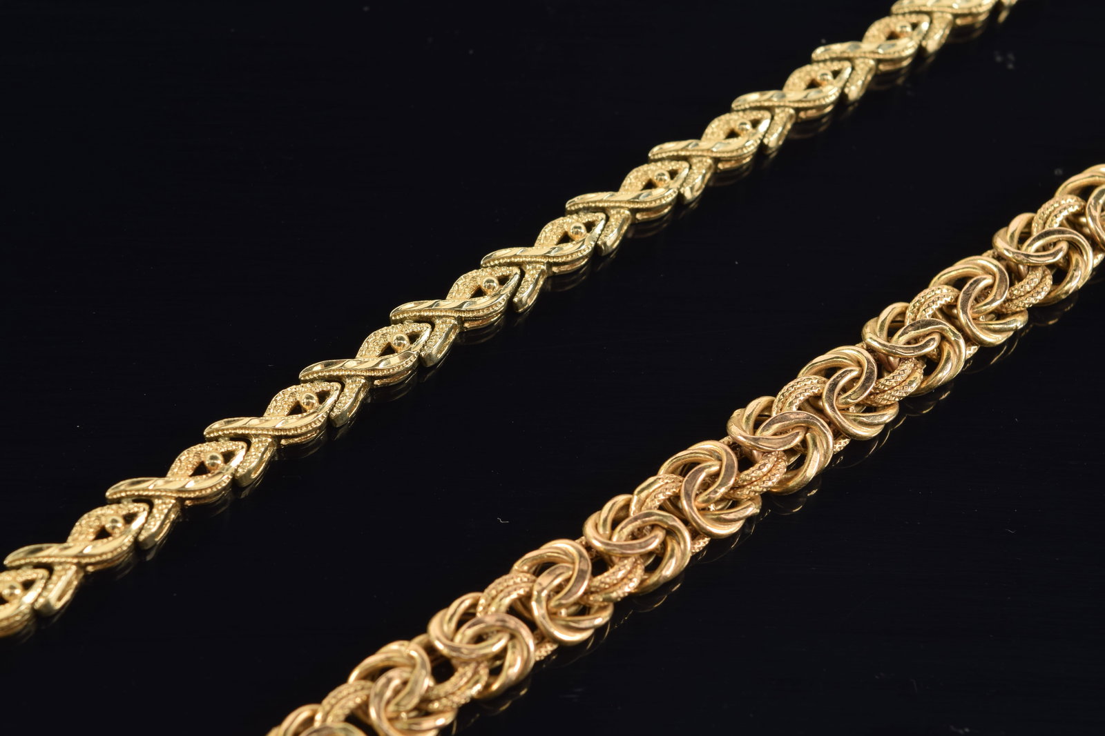 2 14K gold bracelets. One fancy rope and the other a heavy bead and ribbon design. Each marked 14K. (1 of 4)