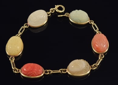 14K gold scarab bracelet. Set with 6 multi colored carved stones. Clasp marked 14K. 7in length. 14.4