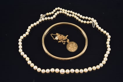 Lot of jewelry, to include: 14K gold charm necklace, 14K gold clasp graduated pearl necklace, and