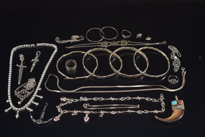 Lot of silver jewelry including cuff bracelets, turquoise and coral mounted claw pendant, chains,