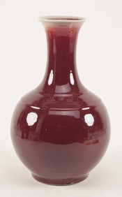 Porcelain vase. China. 19th century. Baluster form with bow string marks. Lang yao deep red glaze.