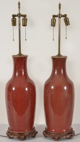 Pair of oxblood vases. China. 19th century. Baluster form. Truncated, drilled and mounted as lamps.