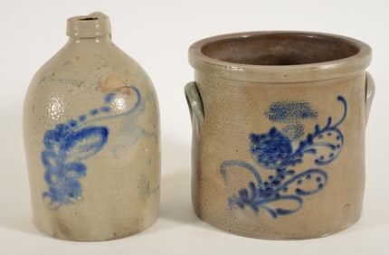 Two stoneware items with cobalt decorations, a one gallon jug with a floral decoration and New York