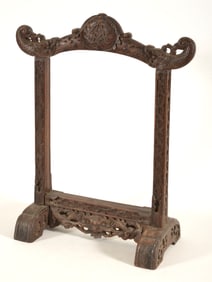 Carved Chinese style frame for hanging bell or ornament. Dragon heads with carved monogram crest.