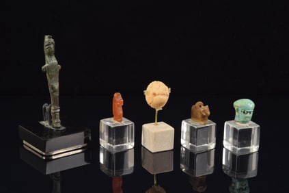 5 amulets. To include: 3 dynastic Egyptian works together with a Roman ivory lion's head and a small