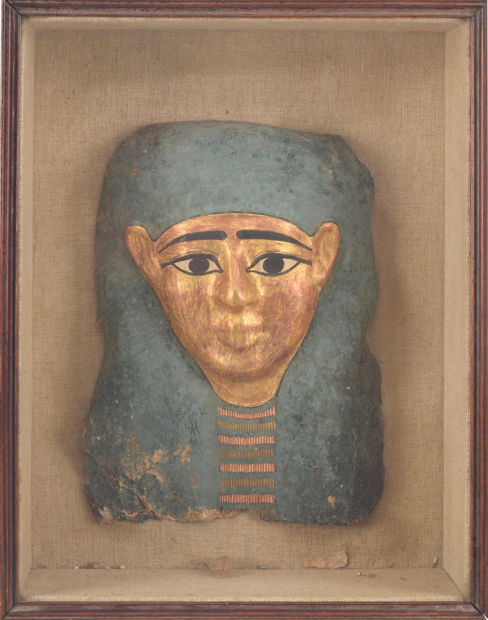 Cartonage mummy mask. Ptolemaic period, 2nd century BC. Mask approximately 13 x 8in. Sealed in: Cartonage mummy mask. Ptolemaic period, 2nd century BC. Mask approximately 13 x 8in. Sealed in shadow box. Case: 16 x 13in.