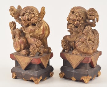 Pair of carved lacquered gilt foo dogs. China. 19th/early 20th century. One with damage. 9.5in high.