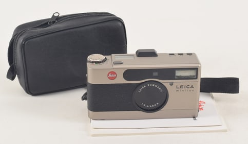 Leica Minilux compact camera. Together with instruction manual and warranty card and leather case.