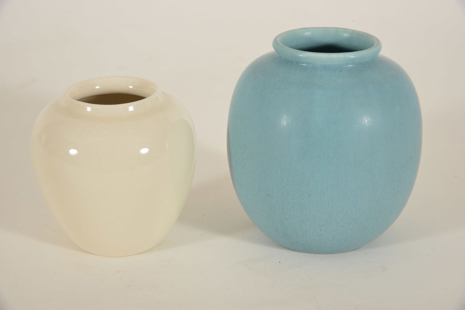 2 Rookwood art pottery small vases with incised marks. White vase, dated 1948, # 1321E and a mottled (1 of 18)