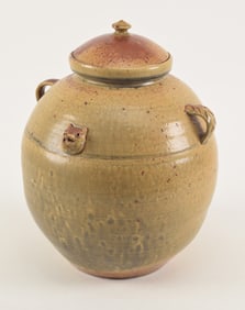 Ovoid pottery jug. 20th century. Fox heads and handles. Signed on base. 12.5 x 12in.