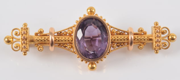 14K gold Etruscan Revival amethyst mounted bar pin. Bead and scrollwork design. Oval cut amethyst