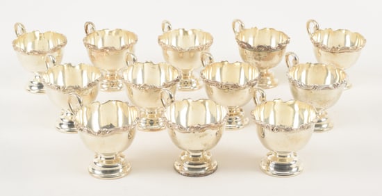 12 sterling silver heavy footed punch cups with handles. Marked Kimberley. 1 with dent in base.
