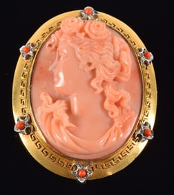 14K gold finely carved cameo pin. Yellow gold frame with white gold applied elements set with coral