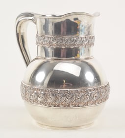 Tiffany & Co. makers sterling silver water pitcher. Scroll and dot pattern decorated panels. 8.5in