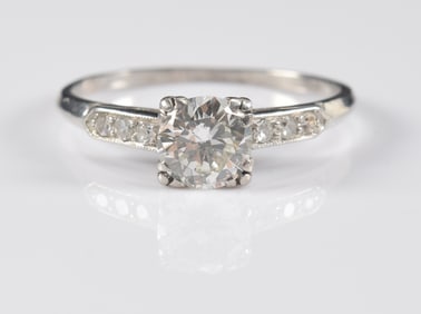 Vintage platinum diamond solitaire ring. Diamond approx. 5.9mm diameter (0.80cts). Flanked by two