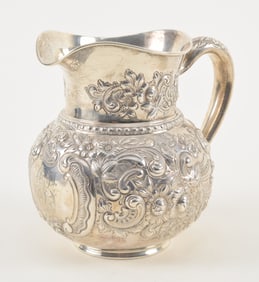 Gorham sterling silver floral repousse decorated water pitcher. Several tiny dings. Light scratches